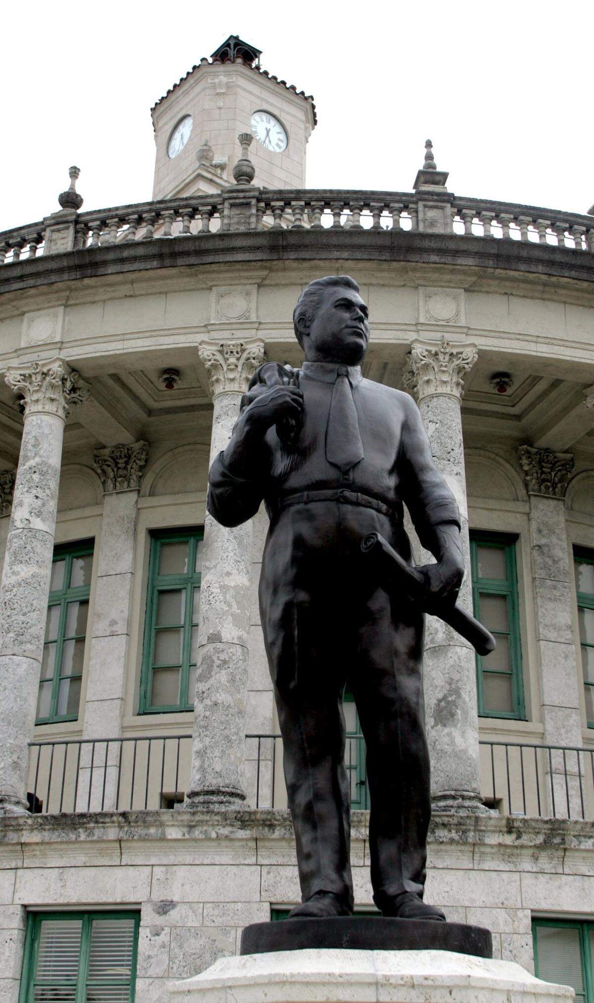 A statue of Coral Gables founder George Merrick stands outside the historic City Hall building.