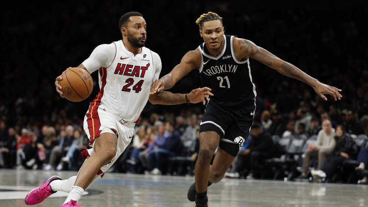 Norman Powell #24 of the Miami Heat dribbles against Noah Clowney #21 of the Brooklyn Nets during the second half at Barclays Center on December 18, 2025 in the Brooklyn borough of New York City. The Heat won 106-95.
