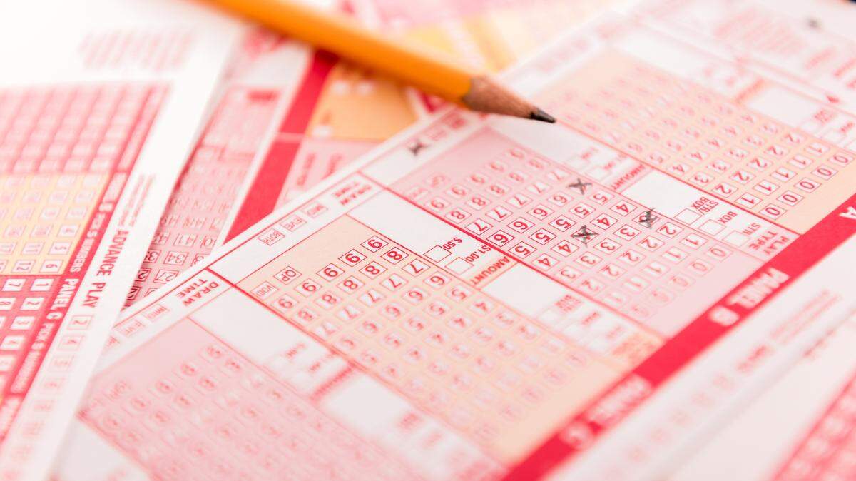Lottery tickets and pen, dangerous path to success and failure.