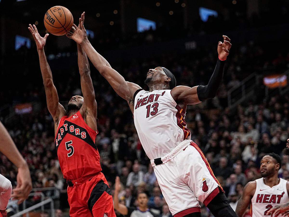 El jugador del Heat de Miami Bam Adbayo (der.) lucha por un rebote con Immanuel Quickley, de los Raptors, en el partido celebrado el 17 de enero de 2024 en Toronto.