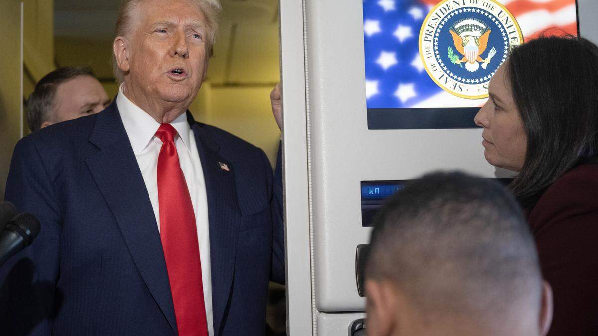 US President Donald Trump (L) speaks to the media aboard Air Force One as he returns to the United States on October 30, 2025. (Photo by ANDREW CABALLERO-REYNOLDS / AFP) (Photo by ANDREW CABALLERO-REYNOLDS/AFP via Getty Images)