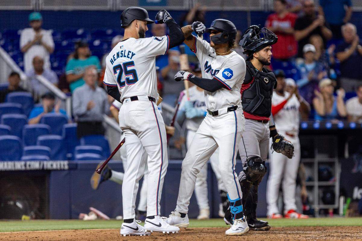 El jardinero central de los Marlins Cristian Paché (der.) celebra con David Hensley tras pegar un jonrón en el cuarto  inning del partido ante los Diamondbacks de Arizona, celebrado el 21 de agosto de 2024 en Miami.