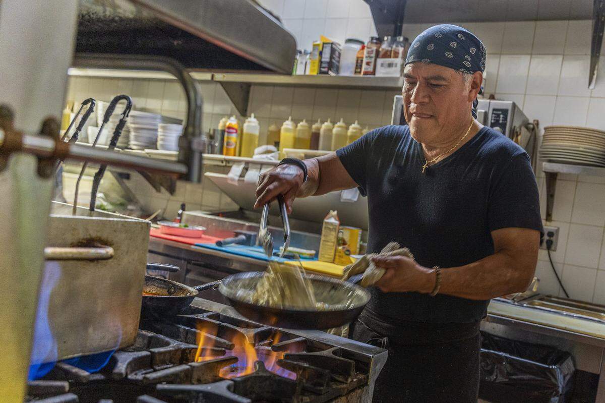 El chef Mateo Zarate prepara una pasta fettuccini Alfredo en la cocina de George’s, restaurante italiano que celebra 25 años en North Beach.