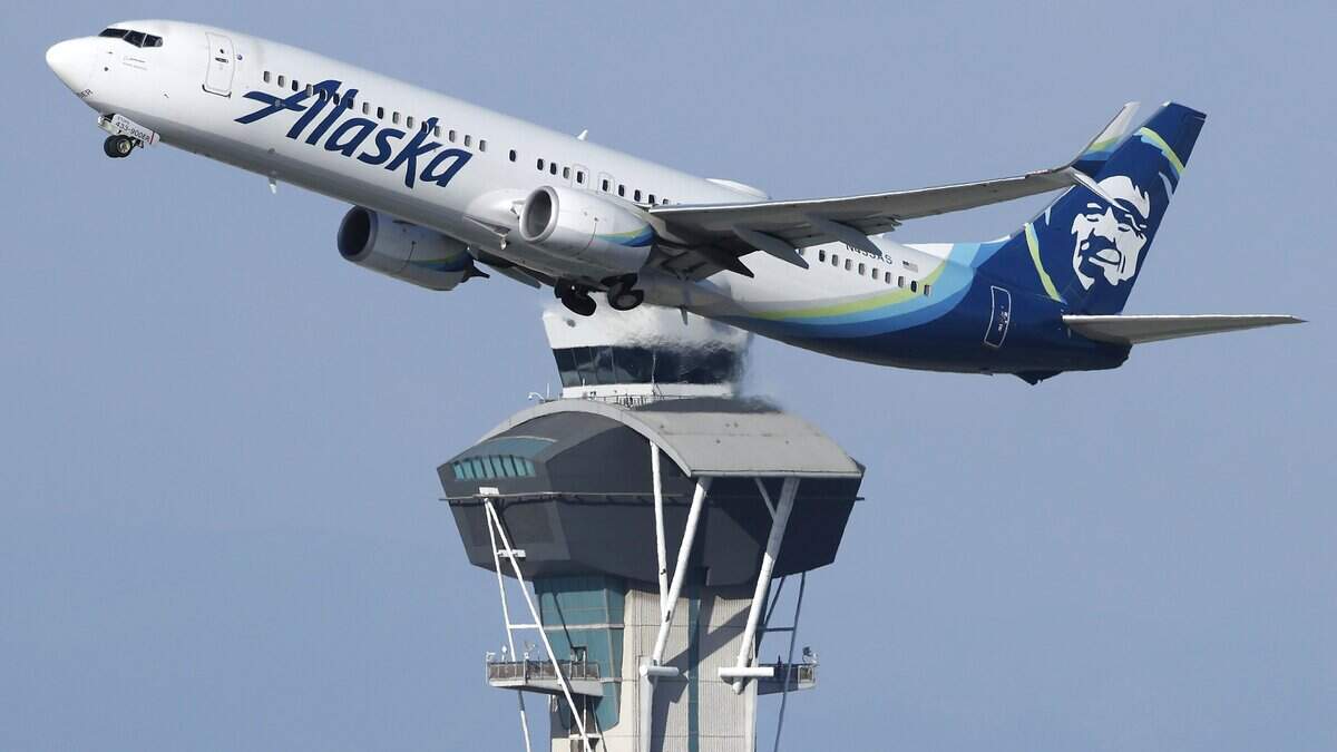 LOS ANGELES, CALIFORNIA - OCTOBER 22: An Alaska Airlines plane takes off near the air traffic control tower at Los Angeles International Airport on October 22, 2025 in Los Angeles, California. The Secretary of Transportation stated yesterday that air traffic controllers could stop receiving a paycheck next week while the federal government shutdown continues. (Photo by Mario Tama/Getty Images)