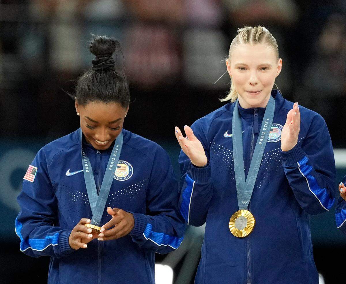 Jul 30, 2024; Paris, France; Simone Biles of the United States looks at her gold medal after the women’s team final at the Paris 2024 Olympic Summer Games at Bercy Arena. Mandatory Credit: Kyle Terada-USA TODAY Sports