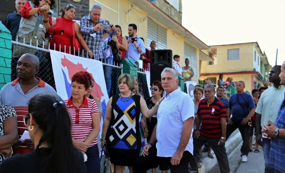 Miguel Díaz-Canel, center right, and his wife, Lis Cuesta Peraza, stand in line to vote in legislative election in Santa Clara on March 11, 2018.