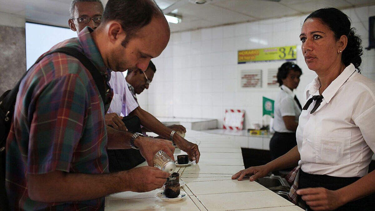 Varias personas toman café en establecimiento del Estado en Santiago de Cuba, el 22 de marzo de 2012.