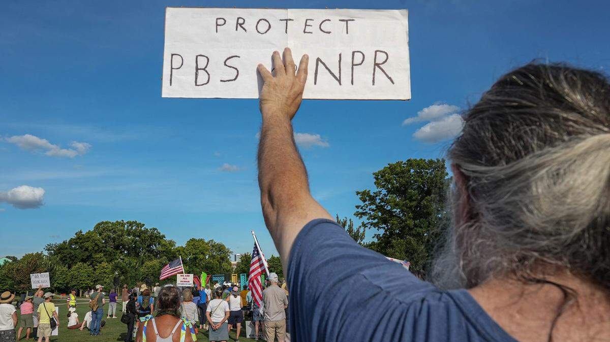 A man who preferred not to be named holds up a sign of his own in support of keeping government funded media giants PBS and NPR, during the Good Trouble rally at Unity Park in Greenville, S.C. Thursday, July 17, 2025. Congress voted to defund public media in July. 