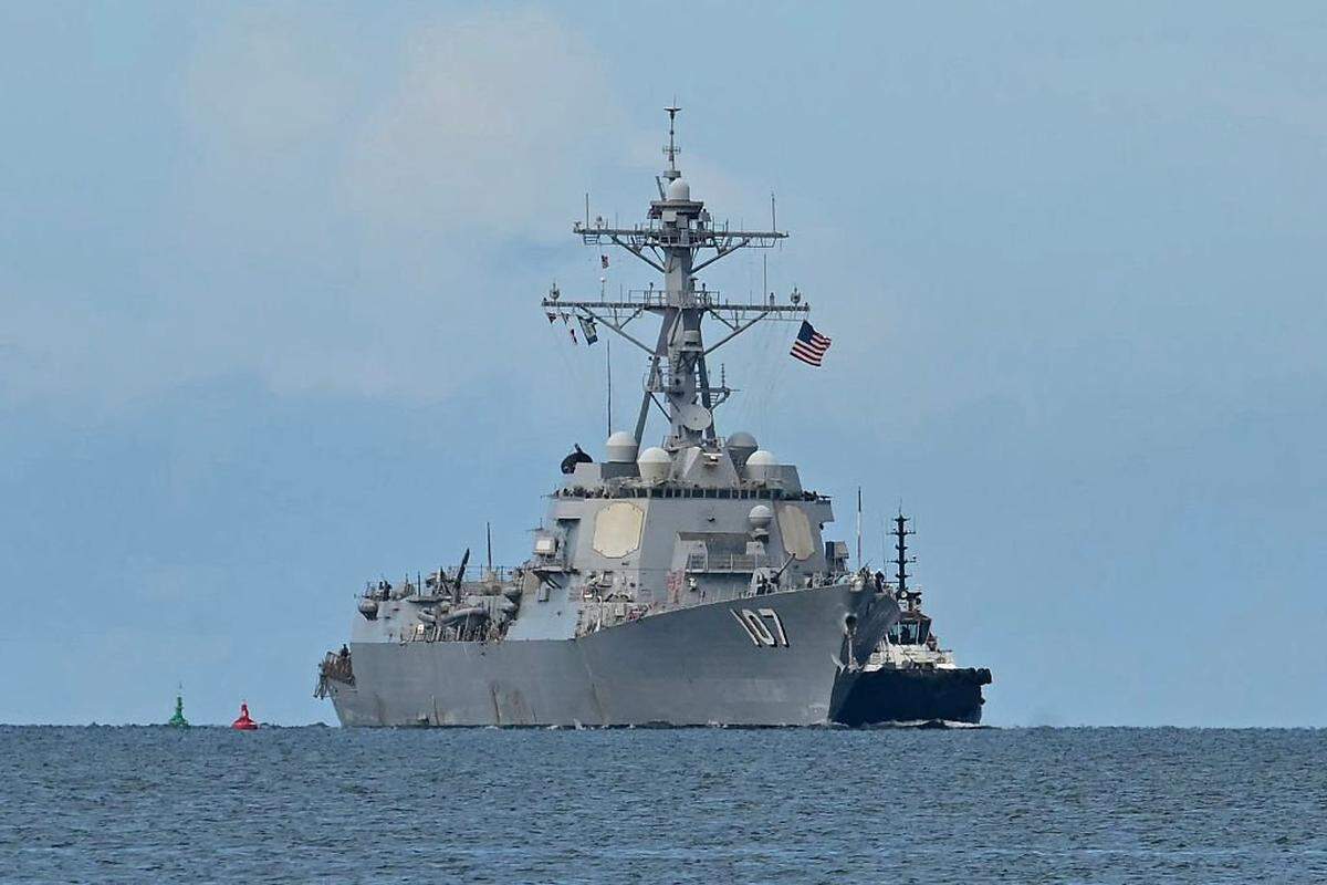 The USS Gravely warship is seen at a distance off the coast of Port of Spain on October 26, 2025. The US warship will visit Trinidad and Tobago for joint exercises near the coast of Venezuela amid Washington's campaign against alleged drug traffickers in the region. (Photo by Martin BERNETTI / AFP) (Photo by MARTIN BERNETTI/AFP via Getty Images)