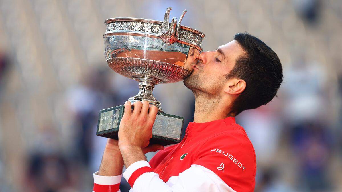 Novak Djokovic besa el trofeo de campeón del Abierto de Francia que obtuvo tras vencer a a Stefanos Tsitsipas en la final, el 13 de junio de 2021 en París.