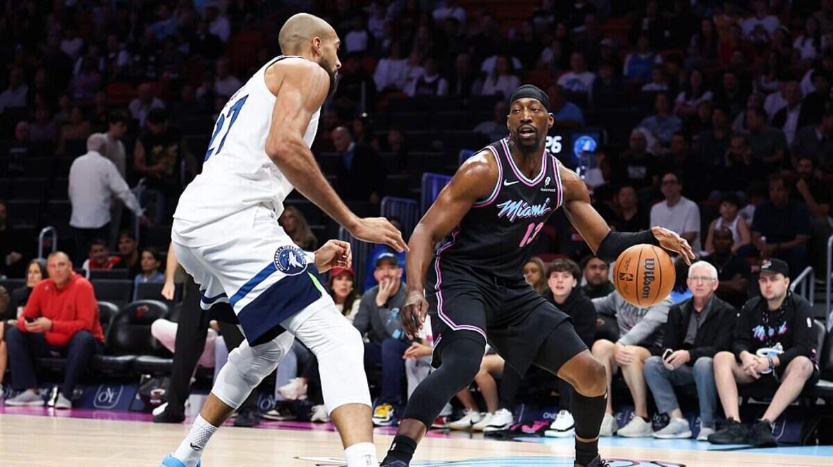 MIAMI, FLORIDA - JANUARY 03: Bam Adebayo #13 of the Miami Heat dribbles the ball against Rudy Gobert #27 of the Minnesota Timberwolves during the first quarter of the game at Kaseya Center on January 03, 2026 in Miami, Florida. NOTE TO USER: User expressly acknowledges and agrees that, by downloading and or using this photograph, User is consenting to the terms and conditions of the Getty Images License Agreement. (Photo by Megan Briggs/Getty Images)