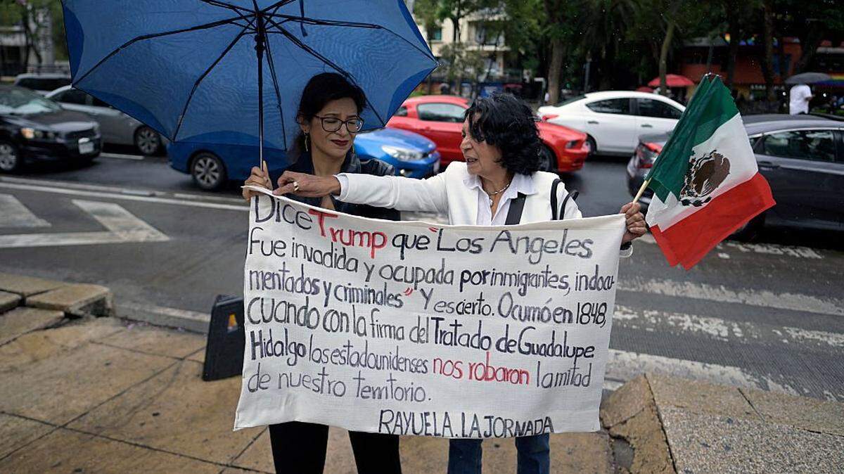 US citizens residing in Mexico hold a sign during a demonstration against US President Donald Trump's immigration policies in front of the US' Embassy in Mexico City on June 14, 2025. (Photo by Alfredo ESTRELLA / AFP) (Photo by ALFREDO ESTRELLA/AFP via Getty Images)
