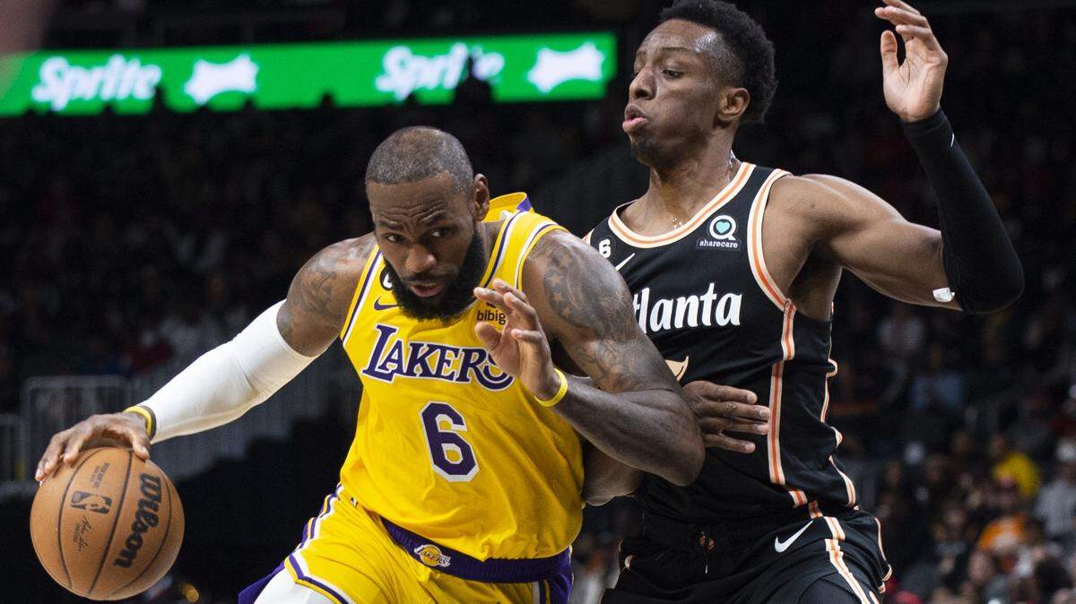 Los Angeles Lakers forward LeBron James drives against Atlanta Hawks forward Onyeka Okongwu during the first half of an NBA basketball game Friday, Dec. 30, 2022, in Atlanta. (AP Photo/Hakim Wright Sr.)