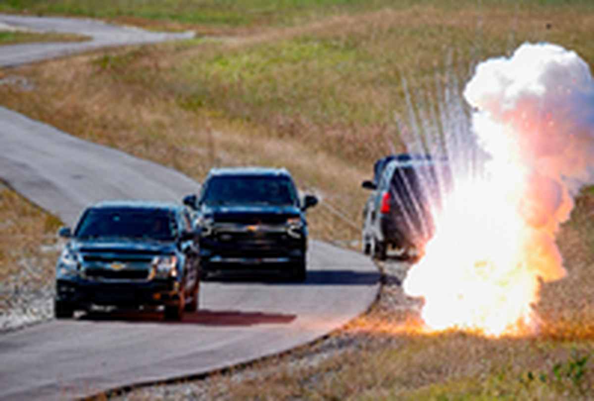 Una caravana de camionetas pasa cerca de una explosión mientras la Oficina del Servicio de Seguridad Diplomática en Miami imparte capacitación sobre protección de dignatarios a los colaboradores de las fuerzas del orden locales, en el Instituto de Capacitación de Seguridad Pública de Miami-Dade, el 10 de noviembre de 2021, en Doral, Florida