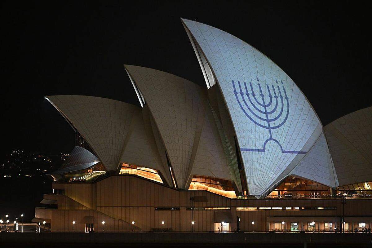 SYDNEY, AUSTRALIA - DECEMBER 15: The Hanukkah menorah, a nine-branched candelabrum lit during the eight day Jewish holiday is projected onto the sails of the Sydney Opera House on December 15, 2025 in Sydney, Australia. Police say at least 16 people, including one suspected gunman, were killed and more than 40 others injured when two attackers opened fire near a Hanukkah celebration at the world-famous Bondi Beach, in what authorities have declared a terrorist incident. (Photo by James D. Morgan/Getty Images)