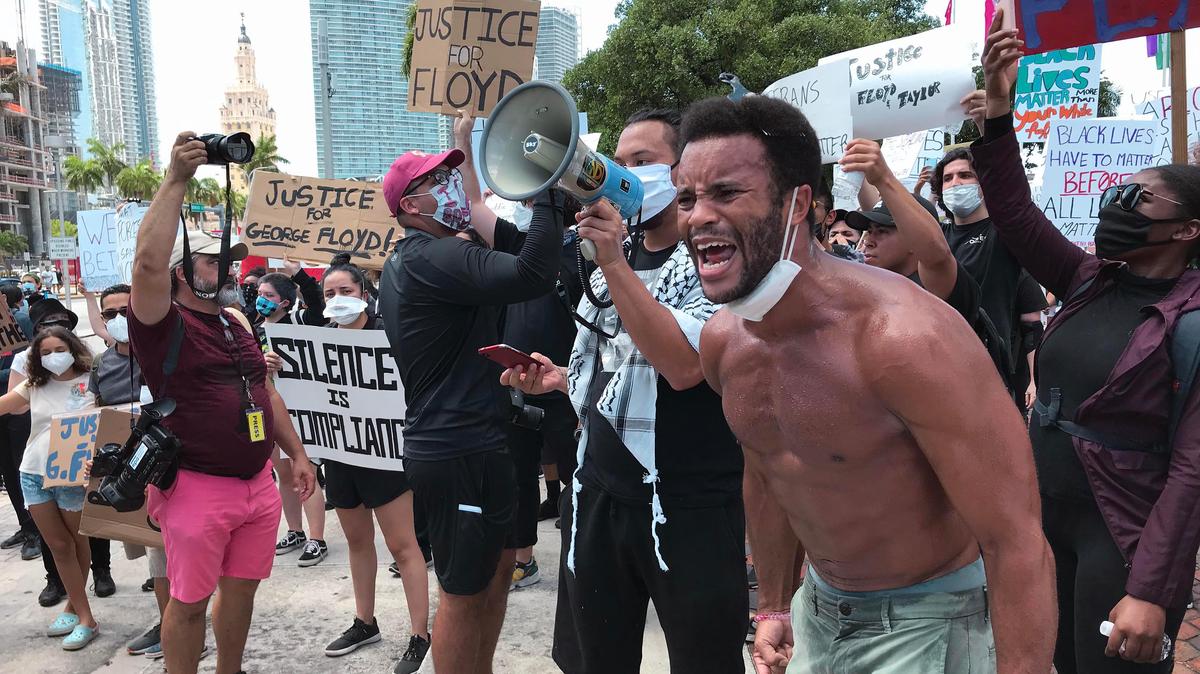 Attendees participate in a protest in a Justice for George Floyd rally at the Torch of Freedom in downtown Miami on Saturday, May 30, 2020.