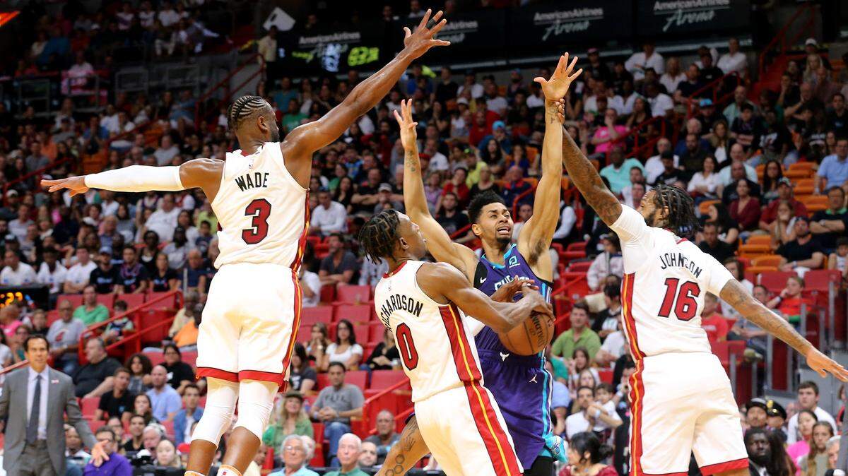 Los jugadores del Heat Dwyane Wade (3), Josh Richardson (0) y James Johnson (16) defienden ante el ataque de Jeremey Lamb (3), de los Hornets, el pasado domingo en Miami.