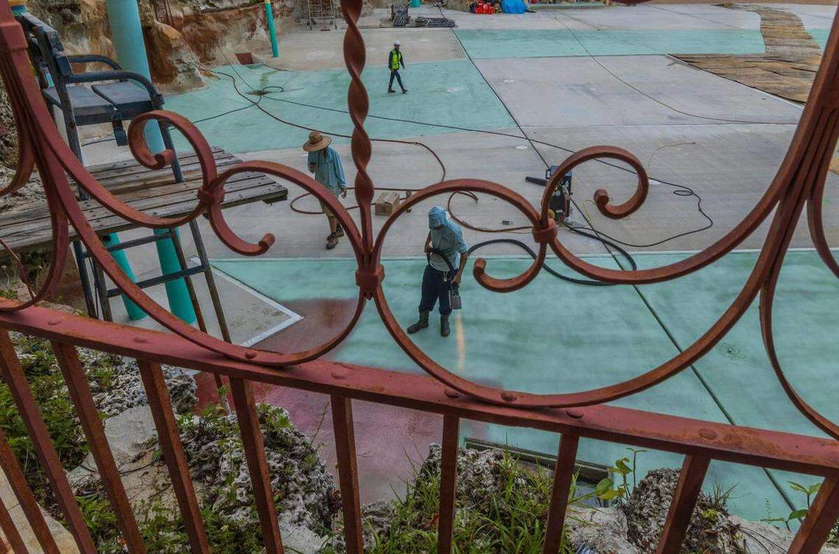 Un trabajador se puede ver usando un lanzallamas para sellar el fondo de la piscina en la Venetian Pool en Coral Gables, el martes 22 de julio de 2025. Pedro Portal pportal@miamiherald.com