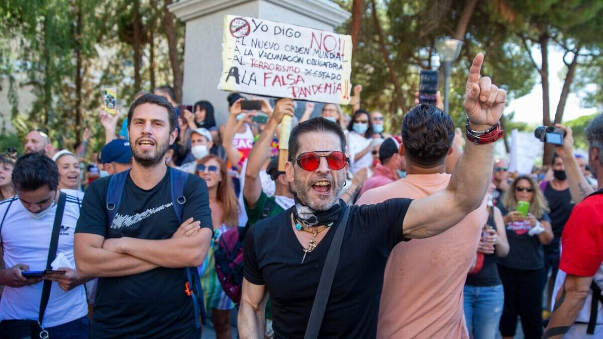 Demonstrators attend a protest against nationwide restrictions against COVID-19 in Madrid, Spain, Sunday, Aug. 16, 2020. (AP Photo/Andrea Comas)