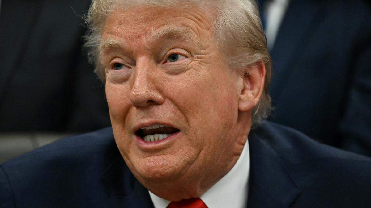 US President Donald Trump speaks during a bill signing ceremony with members of the 1980 US Olympic men's ice hockey team in the Oval Office of the White House in Washington, DC, on December 12, 2025. The legislation will award all of the players with Congressional Gold Medals to recognize the 45th anniversary of the US victory at the 1980 Winter Olympic Games. (Photo by Jim WATSON / AFP via Getty Images)