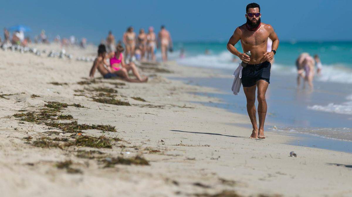 Gus Martinez, 37, jogs toward South Pointe Park Pier in Miami Beach, Florida on Monday, February 15, 2021.