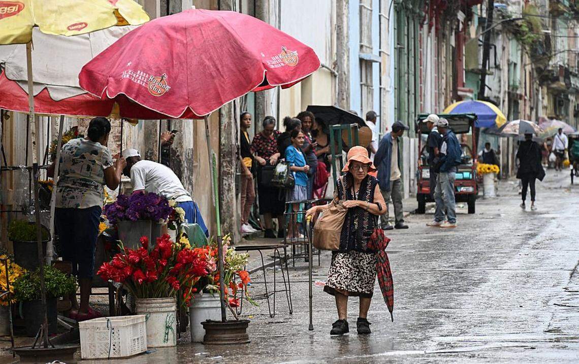 People walk on a street in Havana on January 12, 2026. Cuba's President Miguel Diaz-Canel reacted defiantly to US President Donald Trump's threats to "make a deal" or pay the price in the aftermath of key ally Nicolas Maduro's ouster in a US military raid. (Photo by YAMIL LAGE / AFP via Getty Images)