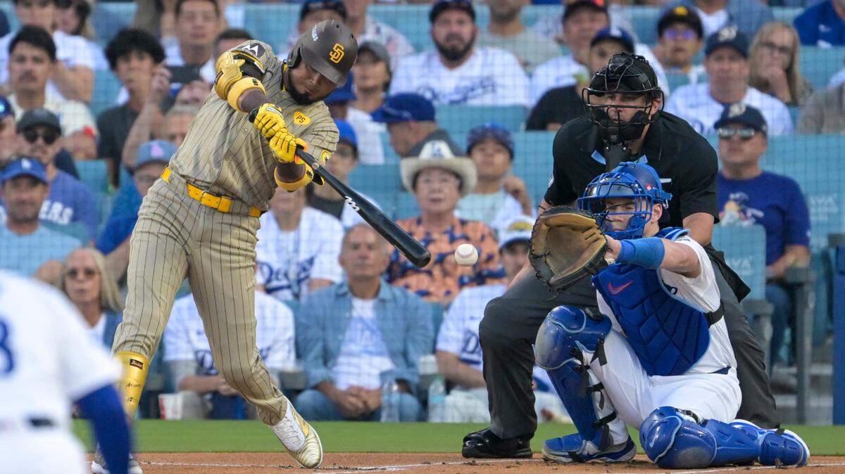 Oct 5, 2024; Los Angeles, California, USA; San Diego Padres first baseman Luis Arraez (4) hits a single in the first inning against the Los Angeles Dodgers during game one of the NLDS for the 2024 MLB Playoffs at Dodger Stadium. Mandatory Credit: Jayne Kamin-Oncea-Imagn Images