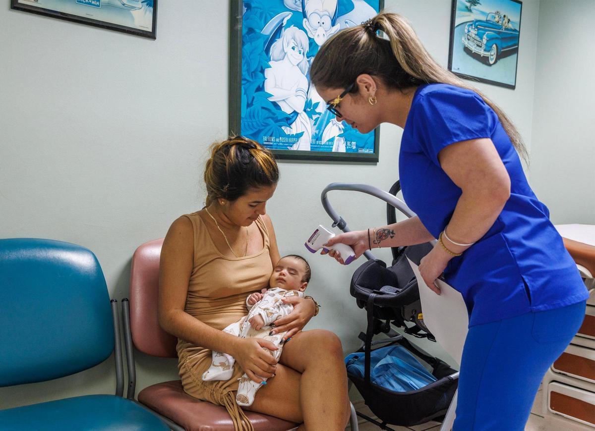 Dayanis Tamayo holds her son Emmanuel Moreno, 7, weeks old, as medical assistant Yisele Gonzalez checks his vitals during a visit to Dr. Julio Egusquiza’s office at Palmetto Hospital in Hialeah. Dayanis, is a refugee from Cuba who arrived from Cuba 9 months ago benefits with the support of the Healthy Steps program, on Friday September 01, 2023.