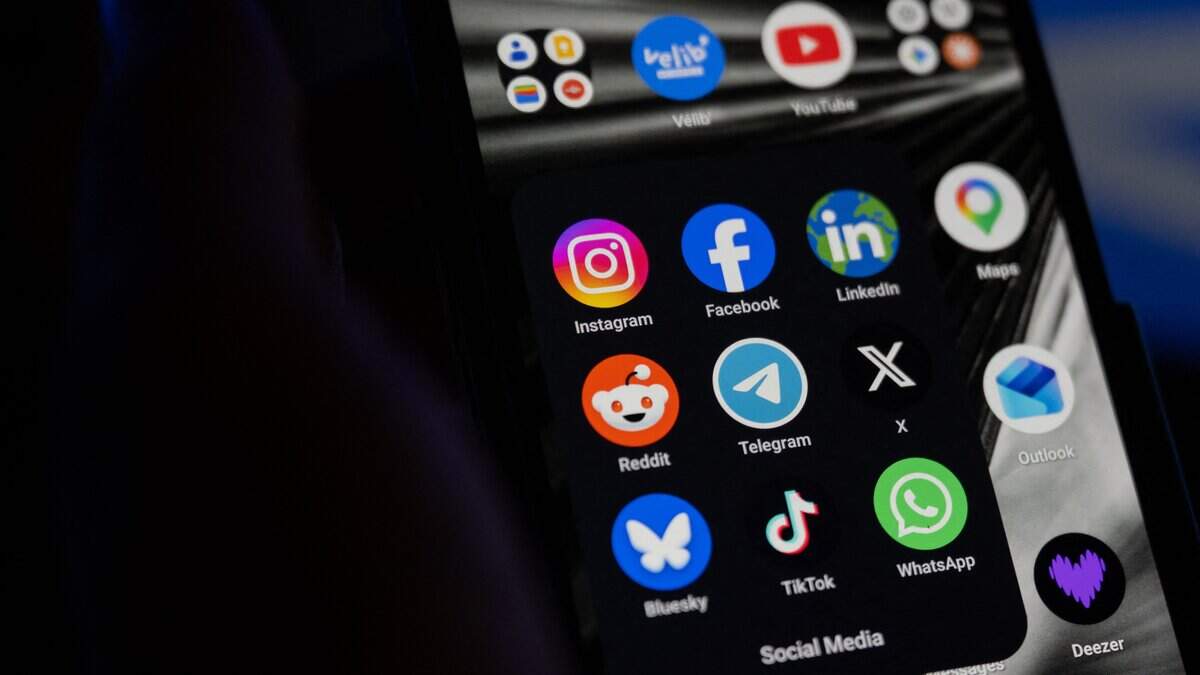 This photograph shows a set up smart-phone screen displaying the logo of main social media platforms including Instagram, Facebook, LinkedIn, Reddit, Telegram, X, Bluesky, Tiktok and Whatsapp in Saint-Mande, east of Paris, on April 29, 2026.  (Photo by Martin LELIEVRE / AFP via Getty Images)