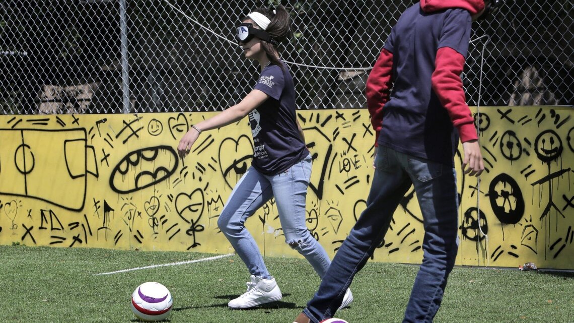 They may be visually impaired, but they love playing soccer