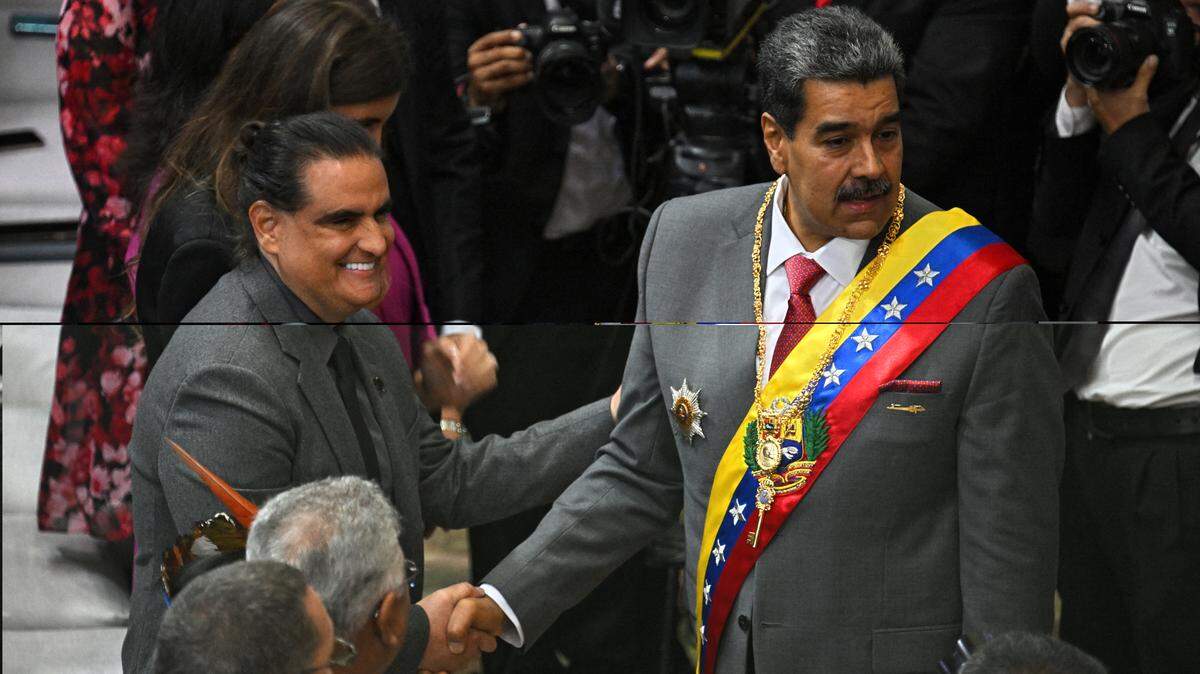 In this file photo, former Venezuelan strongman Nicolás Maduro (right) shakes hands with Colombia-born businessman Alex Saab upon his arrival at the National Assembly headquarters to deliver his state of the nation address to the national assembly in Caracas on Jan. 15, 2024.