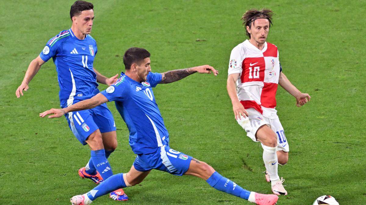 El jugador de Italia Lorenzo Pellegrini (centro) lucha por la pelota con Luka Modric, de Croacia, en el partido de la Eurocopa celebrado el 24 de junio de 2024 en Leipzig, Alemania.
