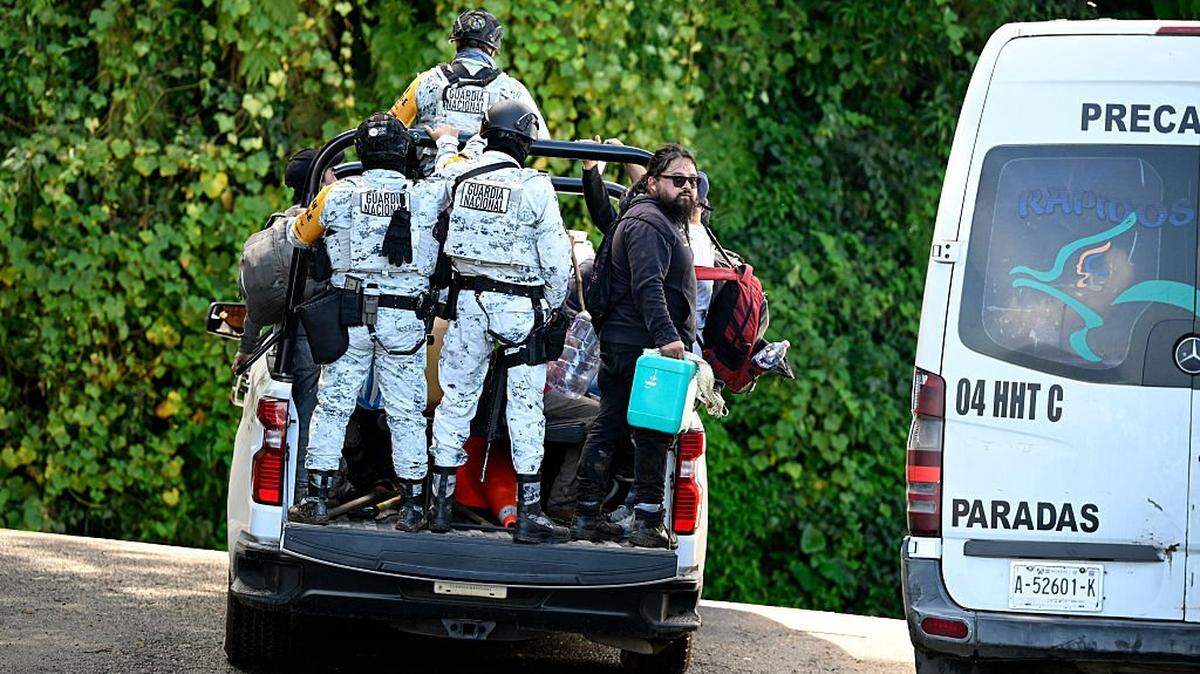 Members of the National Guard transport residents along the TulancingoTenango road to Tulancingo after heavy rains in Hidalgo state, Mexico, on October 12, 2025. The death toll from heavy rains in Mexico rose to 44 after the Mexican government confirmed three more fatalities on Sunday, as civilian and military rescuers struggle to clear roads and reach cut-off communities. (Photo by Alfredo ESTRELLA / AFP) (Photo by ALFREDO ESTRELLA/AFP via Getty Images)          