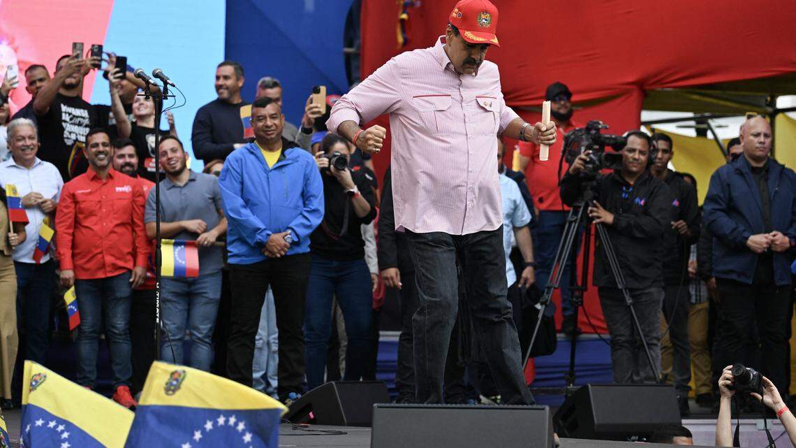 Venezuela's President Nicolas Maduro dances during a rally in Caracas on December 1, 2025. Venezuela does not want "a slave's peace," President Nicolas Maduro told thousands of supporters during a rally, referring to a US military deployment he said has been "testing" his country for 22 weeks. (Photo by Juan BARRETO / AFP via Getty Images)