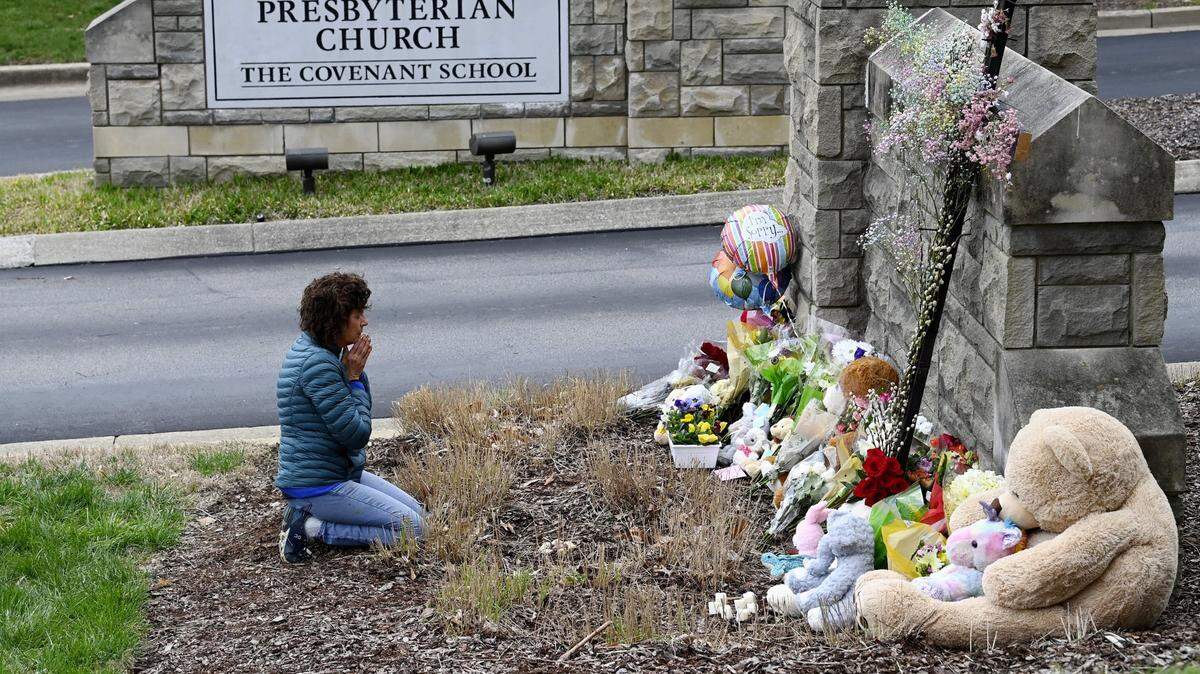 Una mujer reza frente a un monumento improvisado en la entrada de la Escuela Covenant, el martes 28 de marzo de 2023 en Nashville, Tennessee.