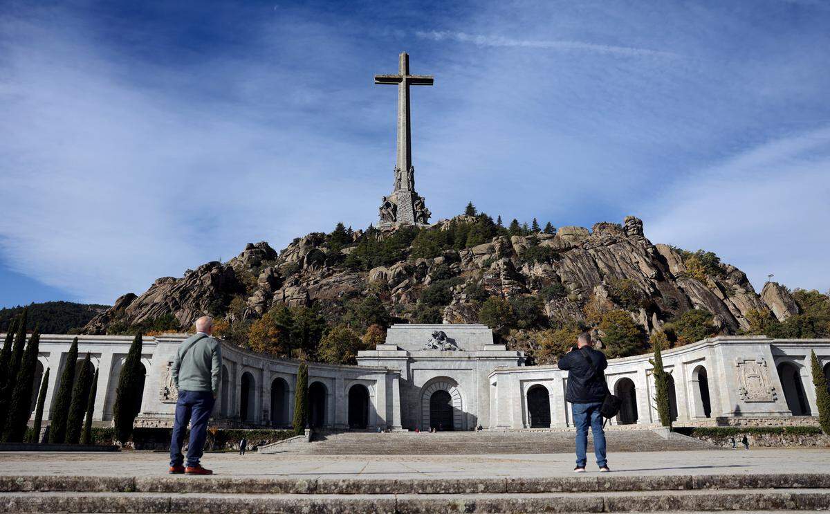 People take pictures as they visit the Valley of Cuelgamuros' Francoist monument, formerly known as El Valle de Los Caidos (The Valley of the Fallen), in San Lorenzo del Escorial, near Madrid. Spain presented yesterday a plan to remodel the basilica of the Valley of Cuelgamuros, formerly known as the Valle de los Caidos (Valley of the Fallen), that was once the burial site of Francisco Franco, days before the 50th anniversary of the dictator's death. The site houses 33,000 bodies from both sides of Spain's 1936-1939 civil war, which was sparked by a military coup that later saw Franco seize power. Franco, who died on November 20, 1975, ordered the monument's construction and was buried at the site. (Photo by Thomas COEX / AFP) (Photo by THOMAS COEX/AFP via Getty Images)