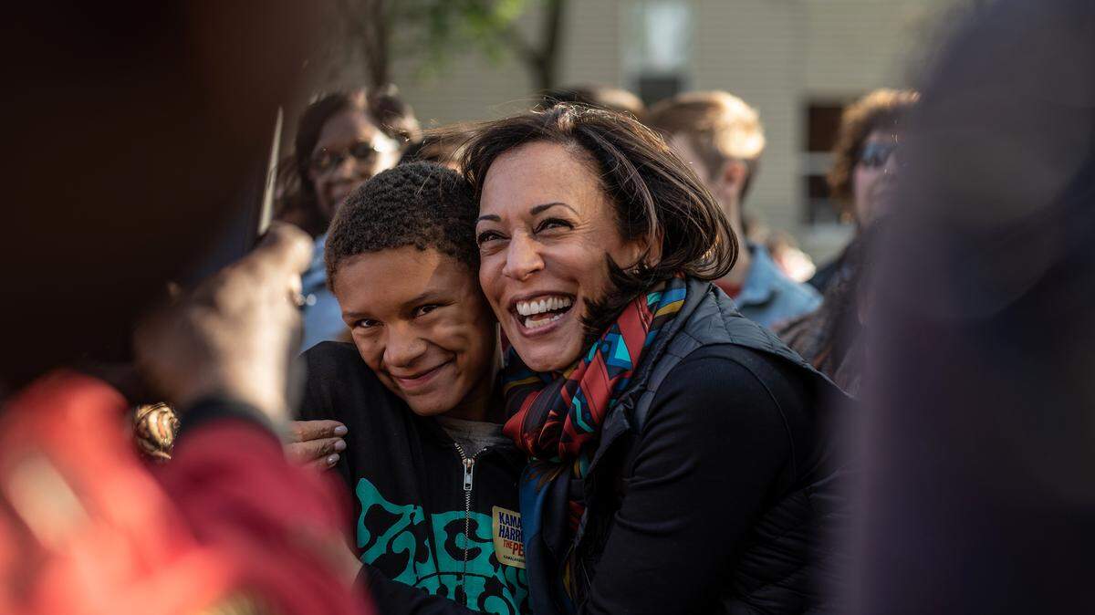 FILE - Sen. Kamala Harris (D-Calif.), a Democratic candidate for president, poses with an attendee at a block party in Des Moines, Iowa, Oct. 12, 2019. In interviews with black voters, many articulated a particular disenchantment with the idea that racial representation equated to change, and that they should automatically back a candidate who looked like them. (Jordan Gale/The New York Times)
