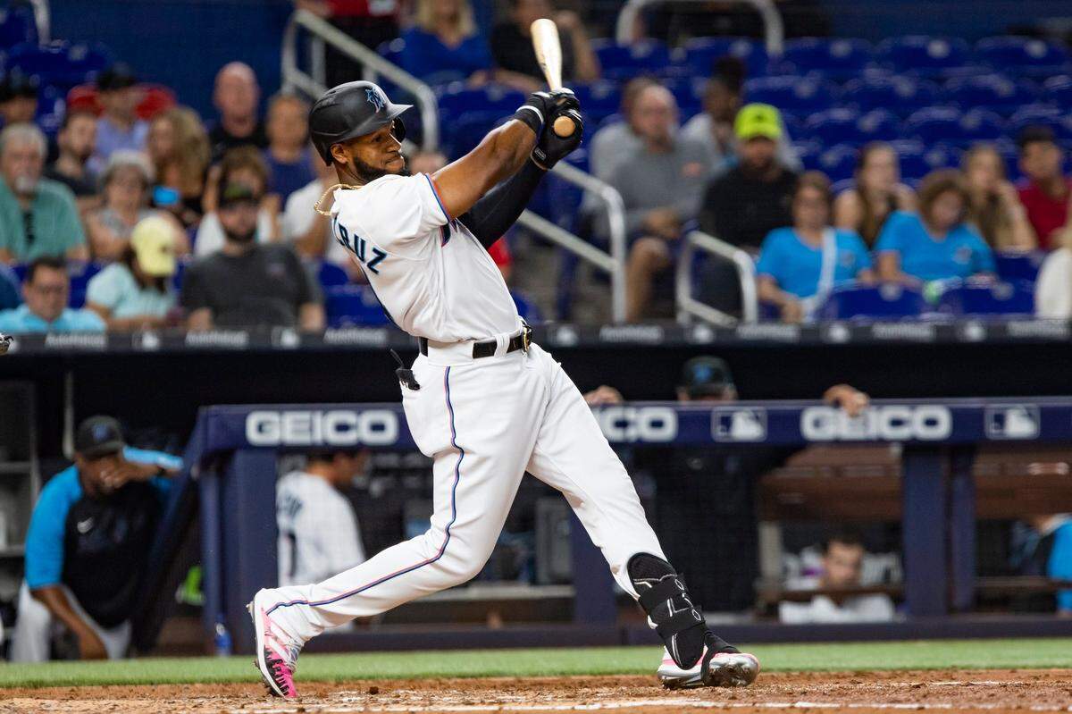 El jardinero de los Marlins Bryan De La Cruz batea un hit en el quinto inning del partido ante los Rojos de Cincinnati, celebrado el 1ro de agosto de 2022 en Miami.