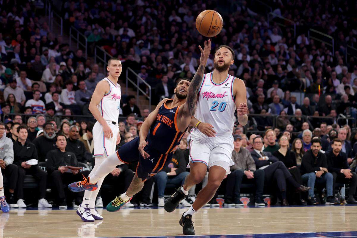 El jugador de los Knicks Cameron Payne (1) tira al aro ante la marca de Kyle Anderson (20) y Tyler Herro (14), del Heat de Miami, en el partido celebrado el 17 de marzo de 2025 en Nueva York.