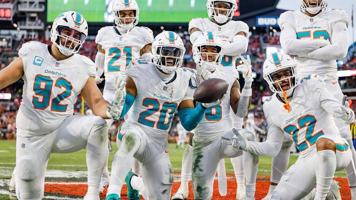 Miami Dolphins linebacker Jordyn Brooks (20) and teammates celebrate after defending against Cleveland Browns wide receiver Jerry Jeudy (3) thought to be a fumble but ruled an incomplete pass during the first half of an NFL Football game at Huntington Bank Field in Cleveland, Ohio on Sunday, December 29, 2024.