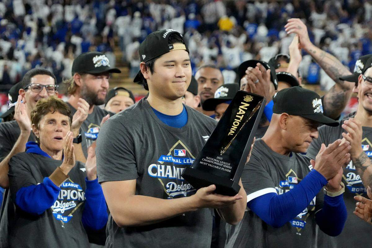 El astro de los Dodgers Shohei Ohtani recibe el trofeo de Jugador Más Valioso de la Serie de Campeonato de la Liga Nacional, el viernes en Los Angeles.