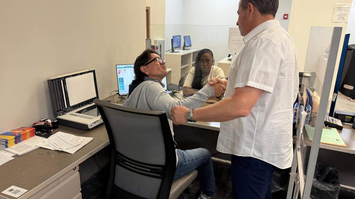 Miami-Dade County Tax Collector Dariel Fernandez visits the Mall of the Americas office where driver’s licenses are processed..