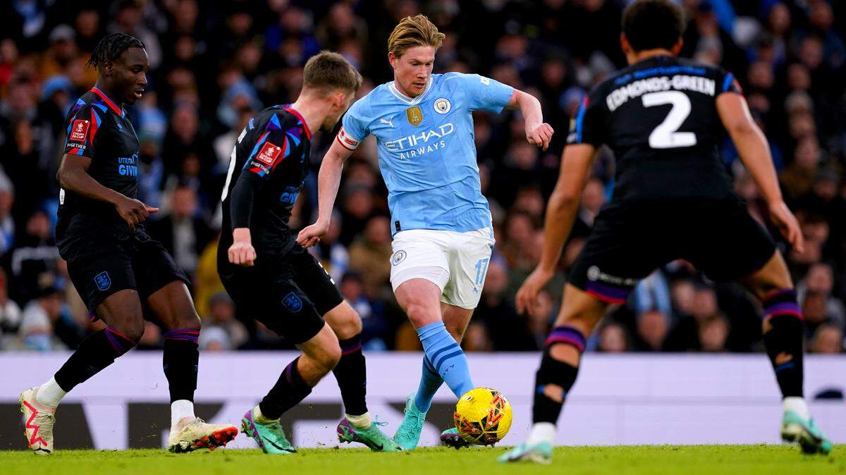 Kevin De Bruyne (centro) asistió con un gol en su retorno de una lesión tras casi cinco meses fuera y el Manchester City inició la defensa de su título de la Copa FA con la goleada 5-0 el domingo ante el Huddersfield, de la segunda división.