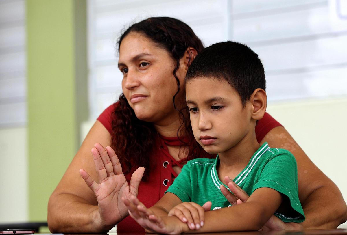 Brenda López holds her son Angel Torres at a school in Puerto Rico. Angel needs medical equipment including a new wheelchair.
