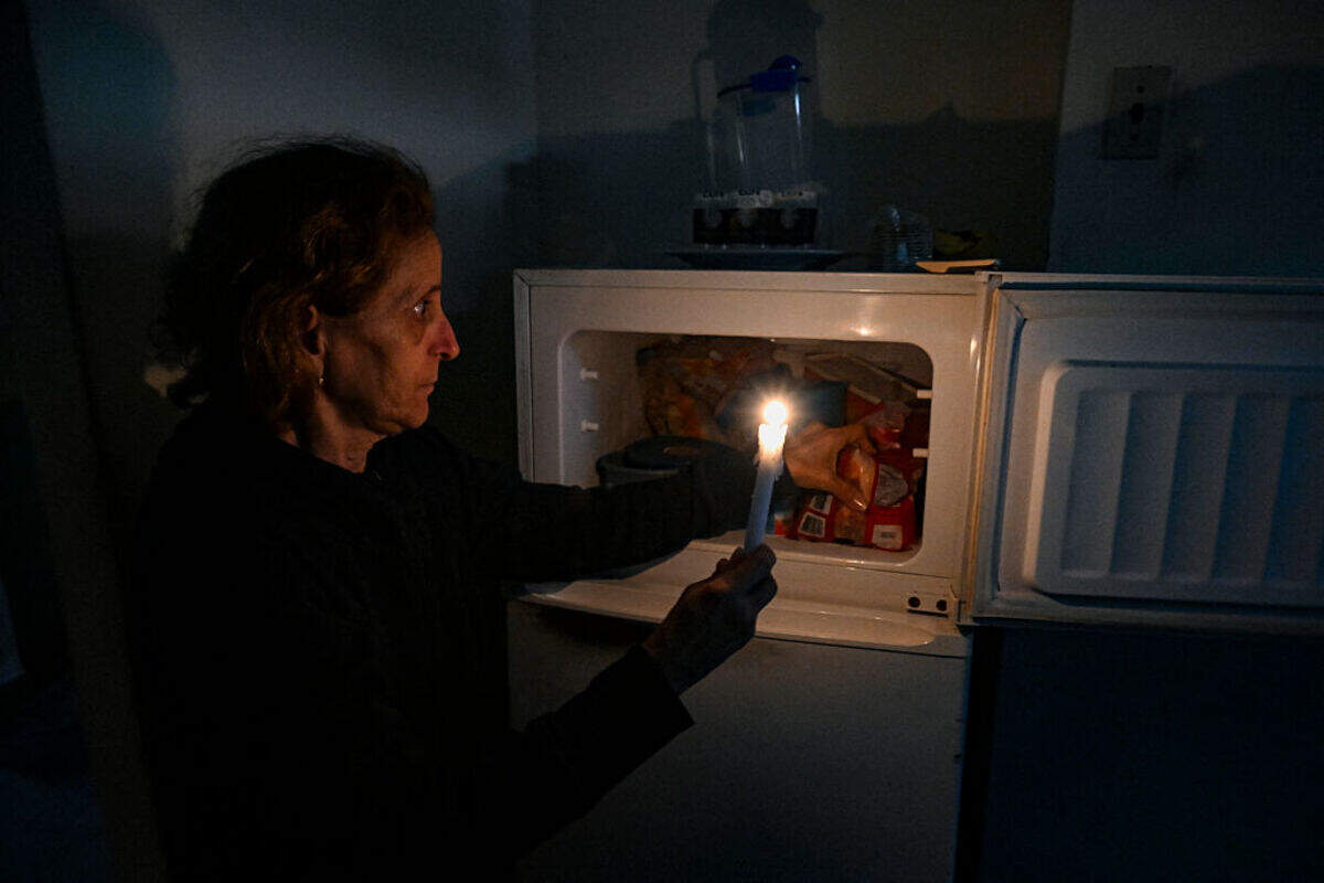 A woman holds a candle during a blackout on Jan. 28, 2026.