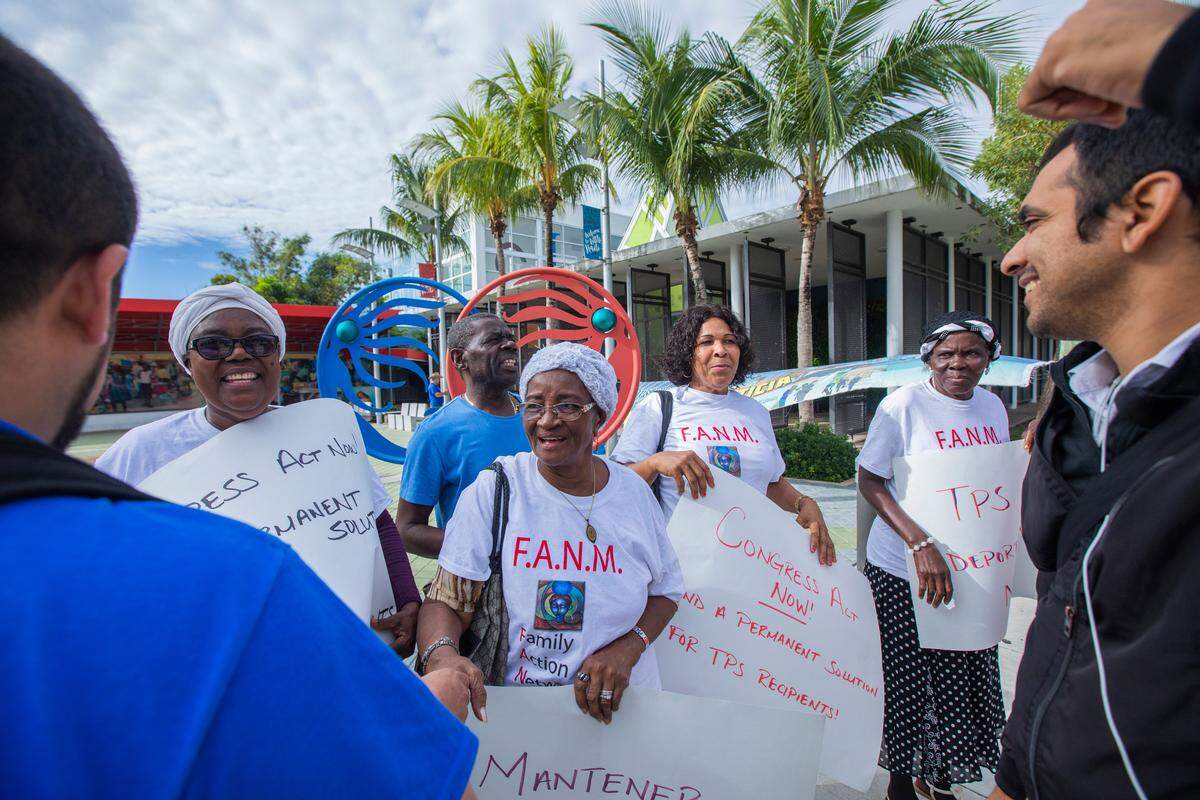 National TPS Alliance members greet Maguerite Davilmar and Monique St. Pharard at the Little Haiti Cultural Center in Miami. The caravan brought TPS holders from Haiti, Somalia, El Salvador, Honduras and Nicaragua.