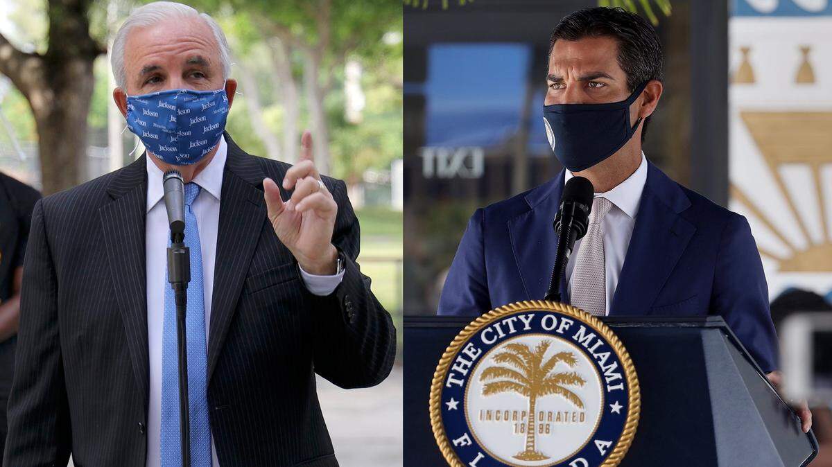 Former Miami-Dade County Mayor Carlos A. Gimenez, left, and Miami Mayor Francis Suarez issued a number of local emergency orders, often conflicting with each other, during the height of the spike in COVID-19 cases in South Florida last year.