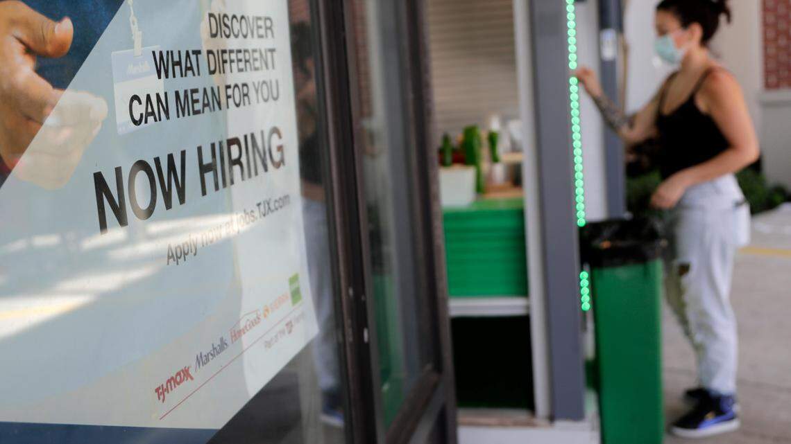A Marshalls retail store displays a Now Hiring sign in Miami. State officials say more than 500,000 jobs in Florida are going unfilled.