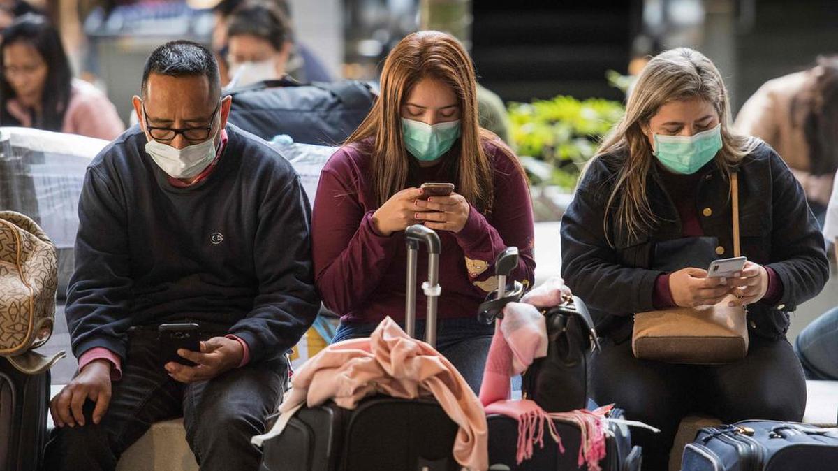Passengers use face masks to protect themselves from the coronavirus after arriving at Los Angeles International Airport from Asia on Jan. 29, 2020.