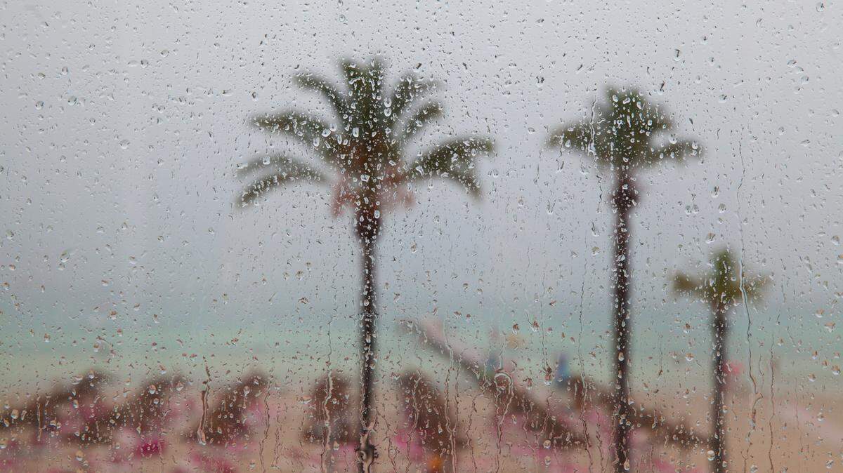 rainy day at the beach, droplets on the window, showers in the tropic paradise